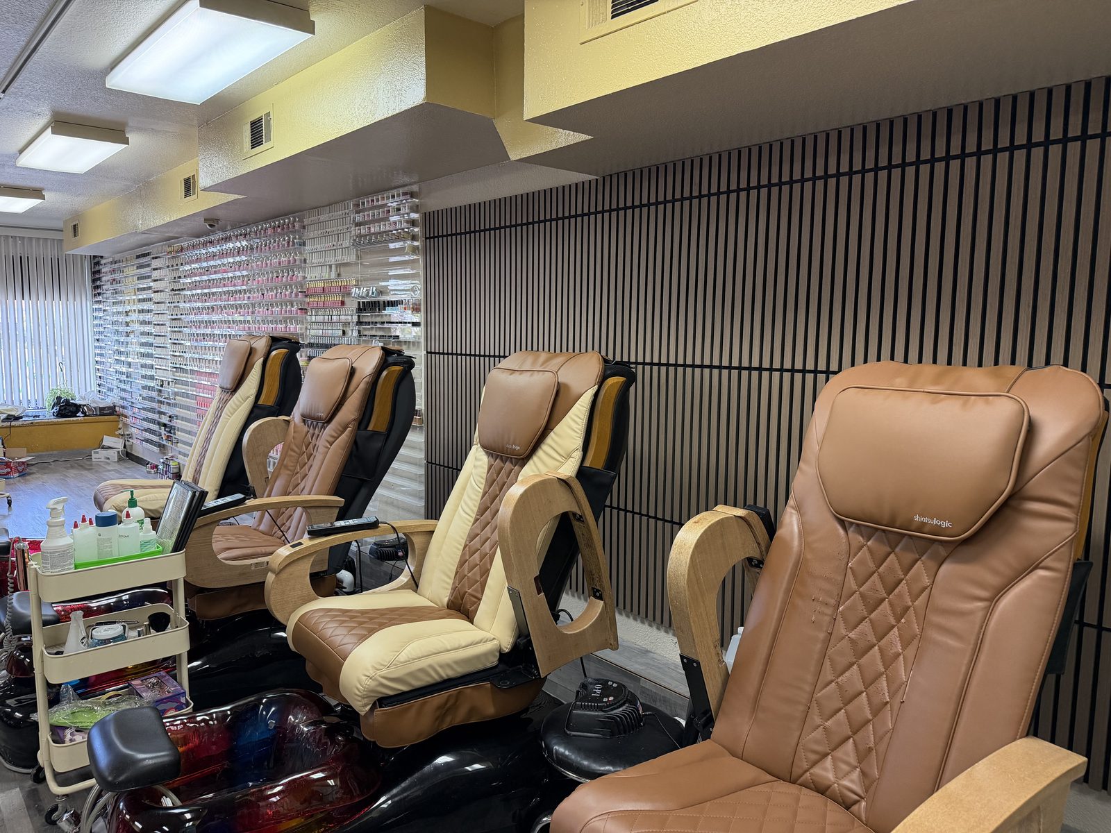 Pedicure massage chairs and amenities cart at MC Nails & Spa